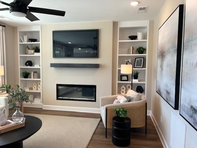 131 W Cassa Way, Mount Juliet, TN 37122 - living room featuring a glass covered fireplace, wood finished floors, built in shelves, and a ceiling fan