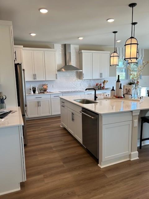 131 W Cassa Way, Mount Juliet, TN 37122 - kitchen featuring wall chimney exhaust hood, appliances with stainless steel finishes, white cabinets, a sink, and recessed lighting