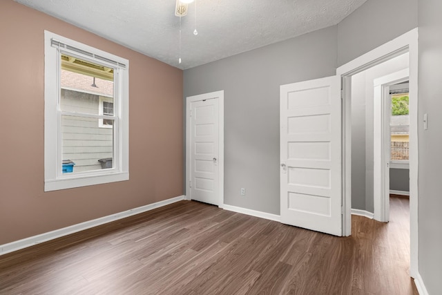 1007 Birdsall St, Old Hickory, TN 37138 - unfurnished bedroom featuring dark wood-type flooring, baseboards, and a textured ceiling