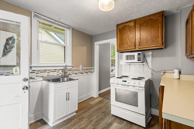 1007 Birdsall St, Old Hickory, TN 37138 - kitchen featuring white appliances, a sink, dark wood-style flooring, a textured ceiling, and brown cabinets