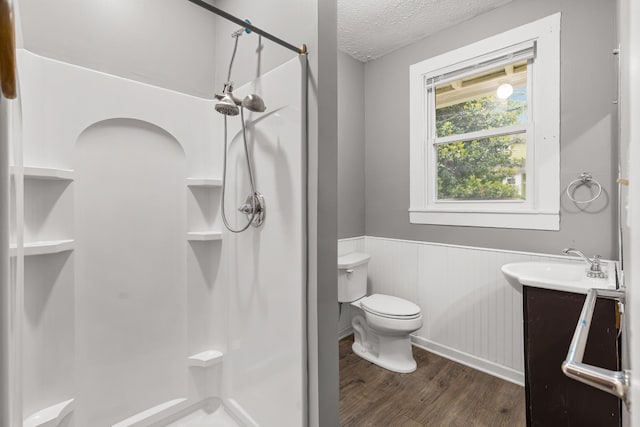 1007 Birdsall St, Old Hickory, TN 37138 - full bathroom with a wainscoted wall, a stall shower, wood finished floors, toilet, and a textured ceiling