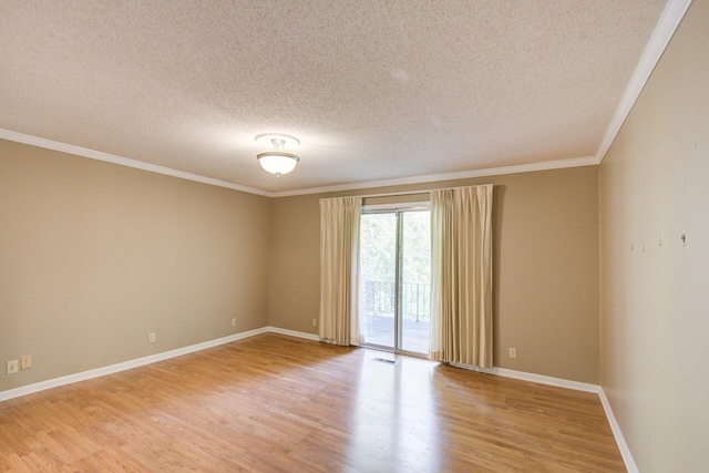 empty room featuring a textured ceiling, light wood-type flooring, ornamental molding, and baseboards
