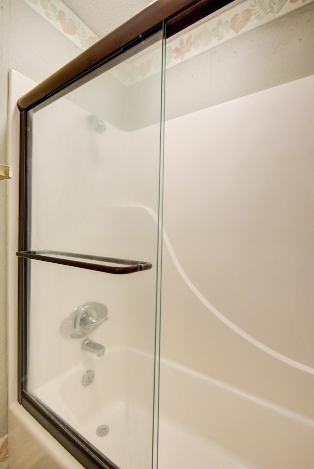 full bathroom with shower / bath combination with glass door