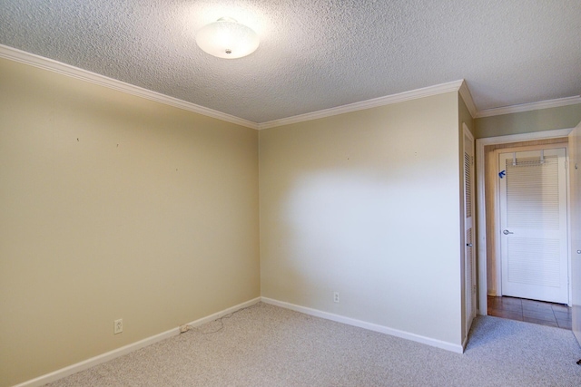 spare room with carpet flooring, baseboards, crown molding, and a textured ceiling