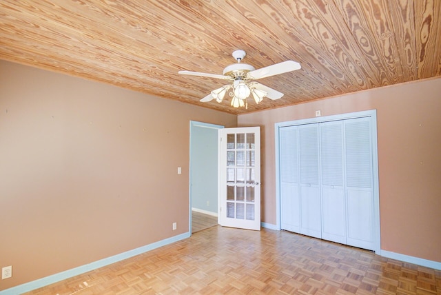 spare room with wooden ceiling, a ceiling fan, baseboards, and french doors