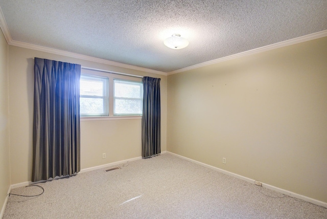 empty room with carpet flooring, ornamental molding, a textured ceiling, and baseboards