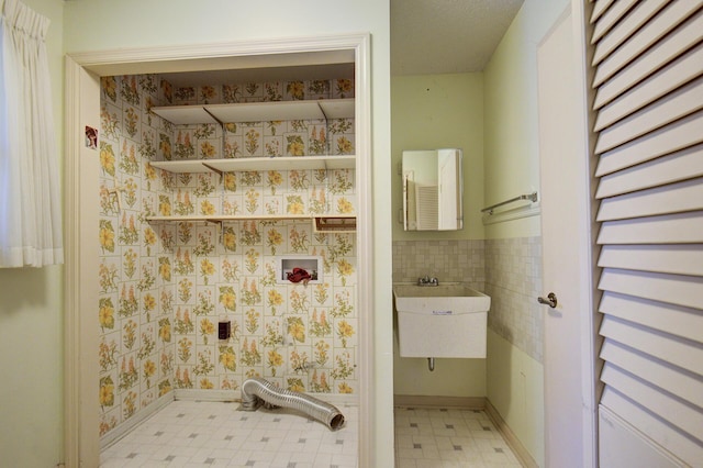 bathroom featuring tile patterned floors and a sink