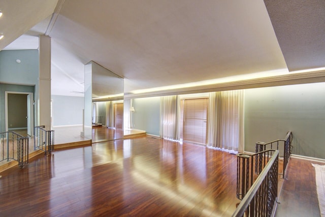 spare room featuring wood finished floors and baseboards