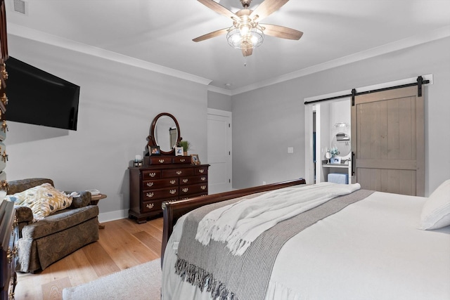 1440 Bowman Rd, Hixson, TN 37343 - bedroom with wood finished floors, ornamental molding, a barn door, a ceiling fan, and baseboards