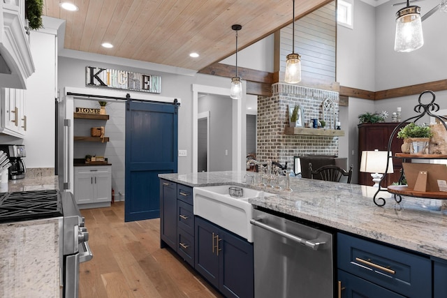 1440 Bowman Rd, Hixson, TN 37343 - kitchen featuring blue cabinets, appliances with stainless steel finishes, a barn door, light wood finished floors, and a sink