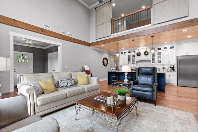 1440 Bowman Rd, Hixson, TN 37343 - living room with a towering ceiling, light wood-type flooring, crown molding, baseboards, and recessed lighting