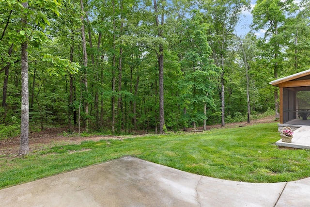 1440 Bowman Rd, Hixson, TN 37343 - view of green lawn with a patio area, a sunroom, and a view of trees