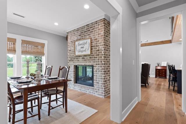 1440 Bowman Rd, Hixson, TN 37343 - dining area with a fireplace, light wood finished floors, recessed lighting, baseboards, and crown molding