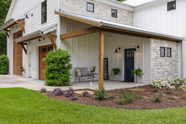1440 Bowman Rd, Hixson, TN 37343 - view of exterior entry featuring board and batten siding, covered porch, and stone siding