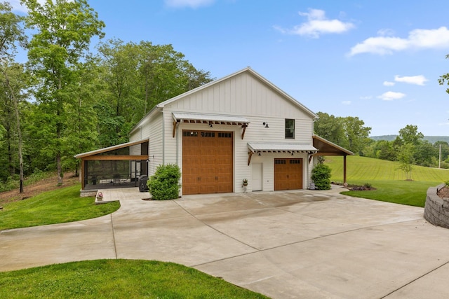 1440 Bowman Rd, Hixson, TN 37343 - view of property exterior featuring board and batten siding, a yard, and concrete driveway