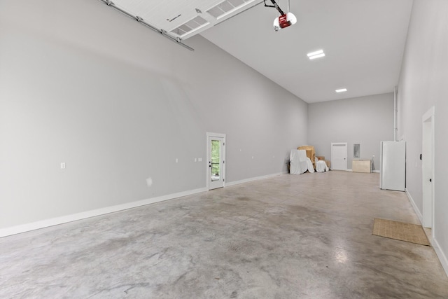 1440 Bowman Rd, Hixson, TN 37343 - garage featuring freestanding refrigerator, a garage door opener, and baseboards