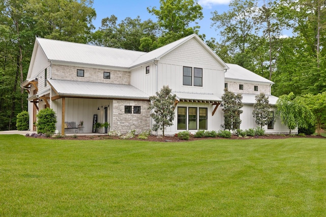1440 Bowman Rd, Hixson, TN 37343 - view of front of home featuring board and batten siding, a front lawn, stone siding, and metal roof