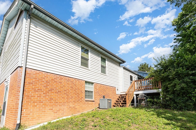 1500 Rice Hill Ct, Antioch, TN 37013 - rear view of property featuring brick siding, a deck, stairway, central AC, and a yard