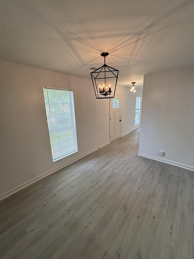3221 New Towne Rd, Antioch, TN 37013 - unfurnished dining area with a chandelier, dark wood-type flooring, and baseboards