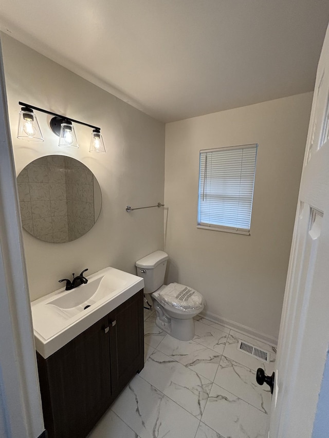 3221 New Towne Rd, Antioch, TN 37013 - half bath featuring marble look tile flooring, toilet, vanity, and baseboards