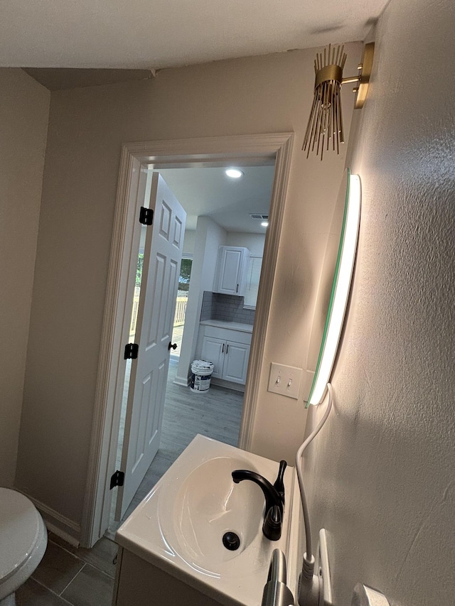 3221 New Towne Rd, Antioch, TN 37013 - bathroom with vanity, tile patterned flooring, baseboards, and tasteful backsplash