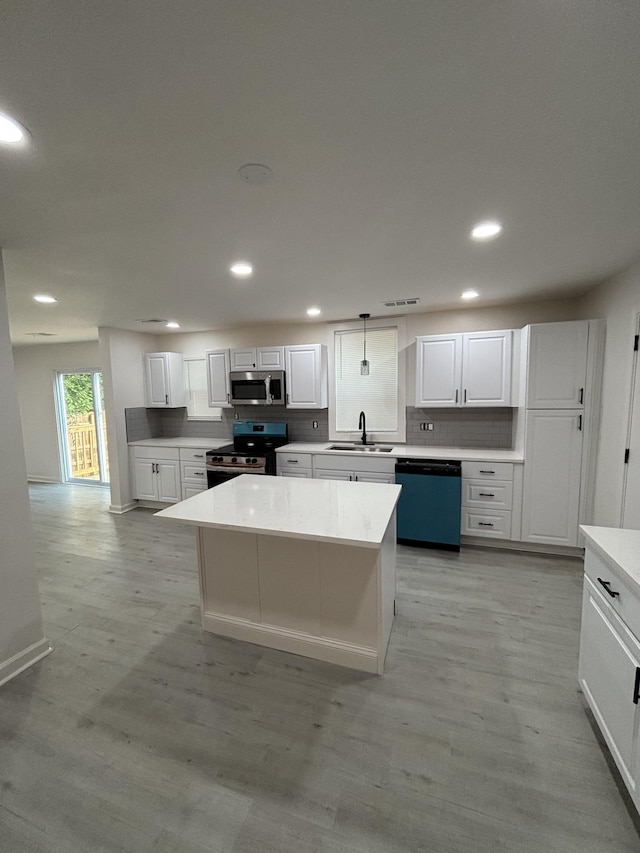 3221 New Towne Rd, Antioch, TN 37013 - kitchen with stainless steel appliances, a sink, backsplash, white cabinetry, and recessed lighting