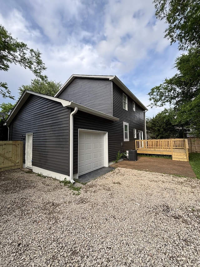 3221 New Towne Rd, Antioch, TN 37013 - view of property exterior featuring an attached garage, a deck, and gravel driveway