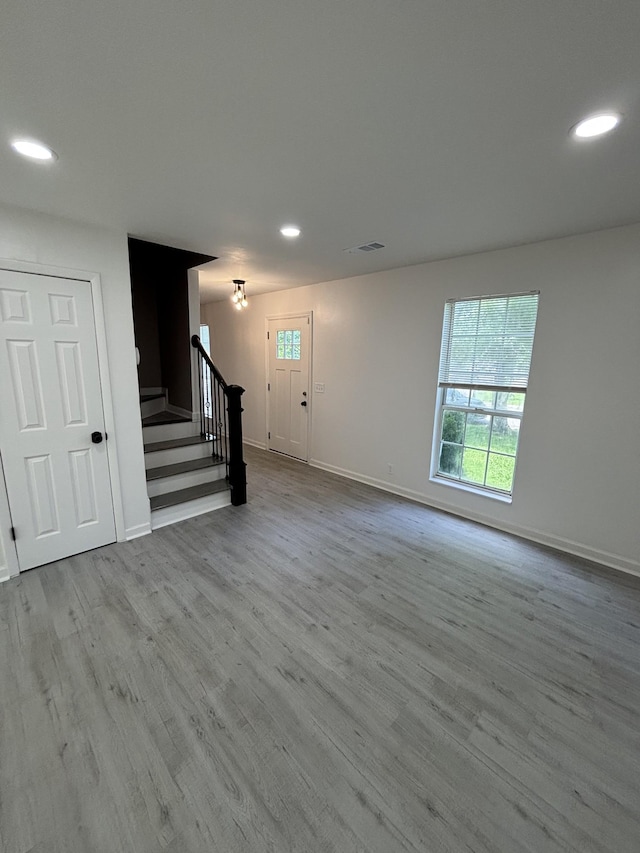 3221 New Towne Rd, Antioch, TN 37013 - unfurnished living room with recessed lighting, stairs, plenty of natural light, baseboards, and wood finished floors