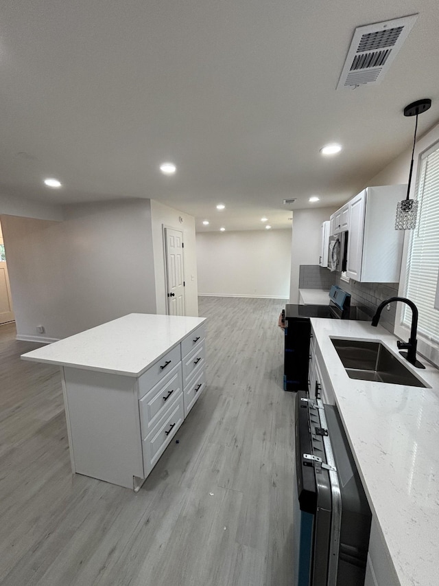 3221 New Towne Rd, Antioch, TN 37013 - kitchen featuring a sink, range with electric cooktop, light wood-style flooring, stainless steel microwave, and baseboards