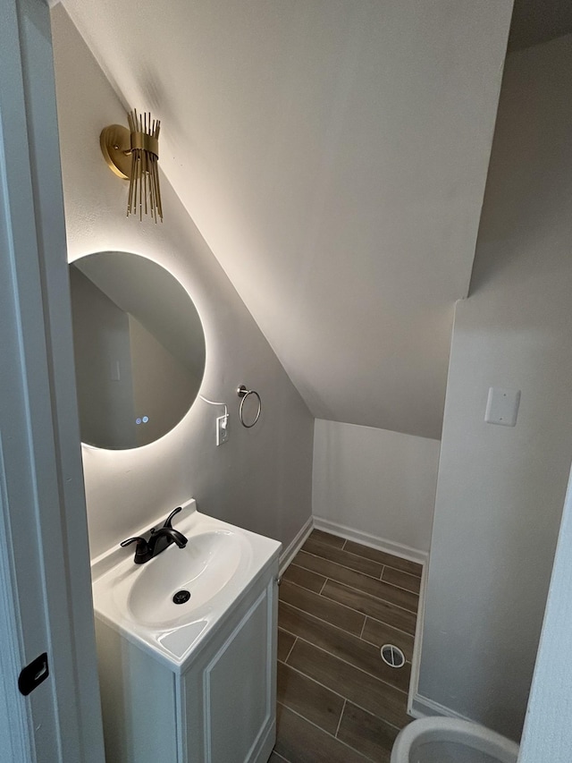 3221 New Towne Rd, Antioch, TN 37013 - bathroom featuring wood tiled floors, vanity, baseboards, and lofted ceiling