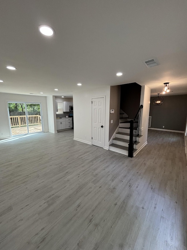 3221 New Towne Rd, Antioch, TN 37013 - unfurnished living room featuring stairway, recessed lighting, a chandelier, wood finished floors, and baseboards
