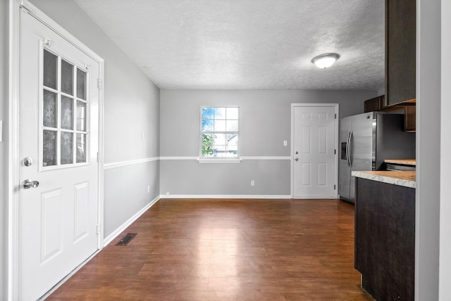 919 Linda Dr, Oak Grove, KY 42262 - unfurnished dining area with dark wood finished floors, a textured ceiling, and baseboards