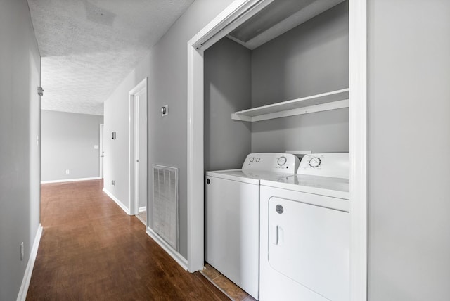 919 Linda Dr, Oak Grove, KY 42262 - laundry area with washer and dryer, a textured ceiling, dark wood-style flooring, and baseboards