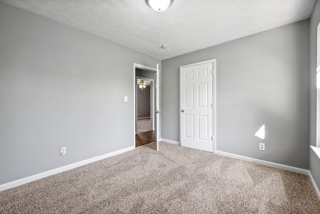 919 Linda Dr, Oak Grove, KY 42262 - unfurnished bedroom featuring carpet, baseboards, and a textured ceiling