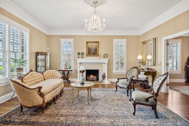 901 Fair St, Franklin, TN 37064 - living area featuring wood finished floors, a warm lit fireplace, baseboards, a chandelier, and ornamental molding