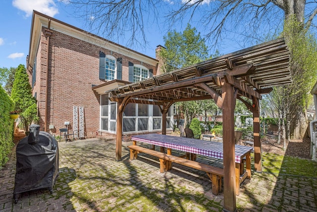 901 Fair St, Franklin, TN 37064 - back of property featuring a pergola, outdoor dining space, brick siding, a patio, and a sunroom
