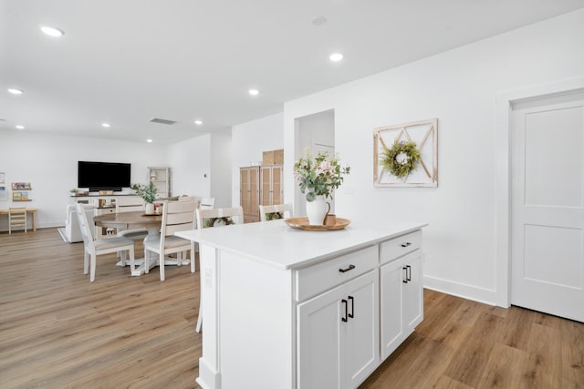 108 Model Ct, Columbia, TN 38401 - kitchen with light wood-style flooring, white cabinetry, light countertops, a center island, and recessed lighting