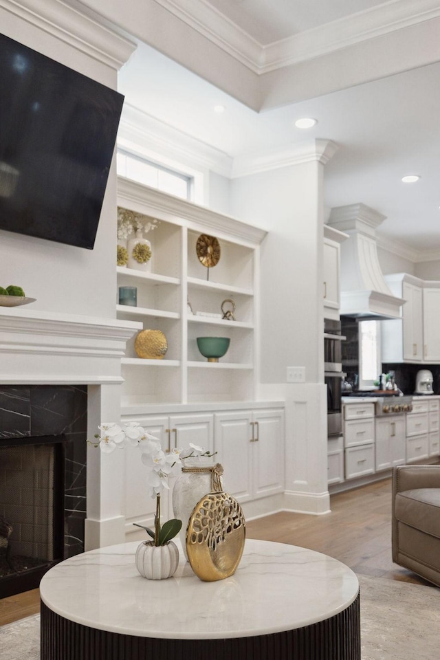 2143 White Poplar Ct, Murfreesboro, TN 37130 - living room featuring light wood-type flooring, recessed lighting, ornamental molding, a fireplace, and built in features