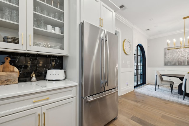 2143 White Poplar Ct, Murfreesboro, TN 37130 - kitchen featuring freestanding refrigerator, ornamental molding, light wood finished floors, glass insert cabinets, and white cabinets