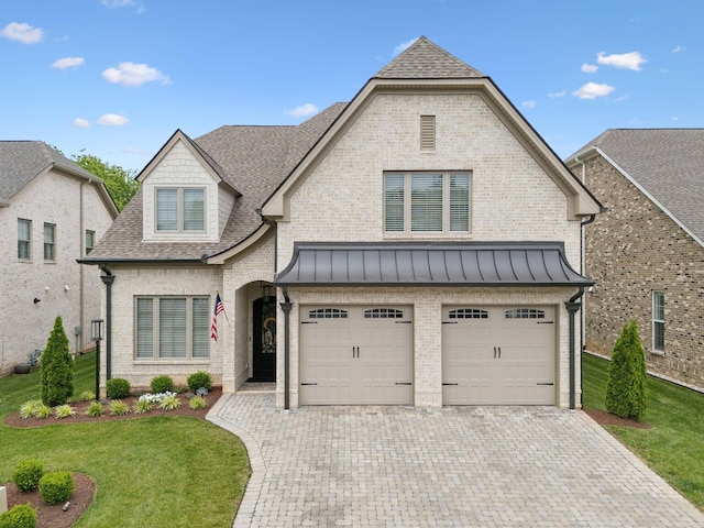 2143 White Poplar Ct, Murfreesboro, TN 37130 - french country home with brick siding, decorative driveway, a garage, a front lawn, and a shingled roof