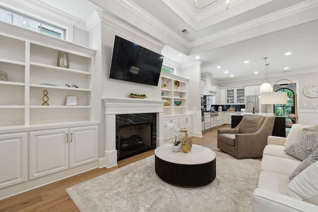 2143 White Poplar Ct, Murfreesboro, TN 37130 - living area featuring light wood-type flooring, healthy amount of natural light, a high end fireplace, crown molding, and recessed lighting