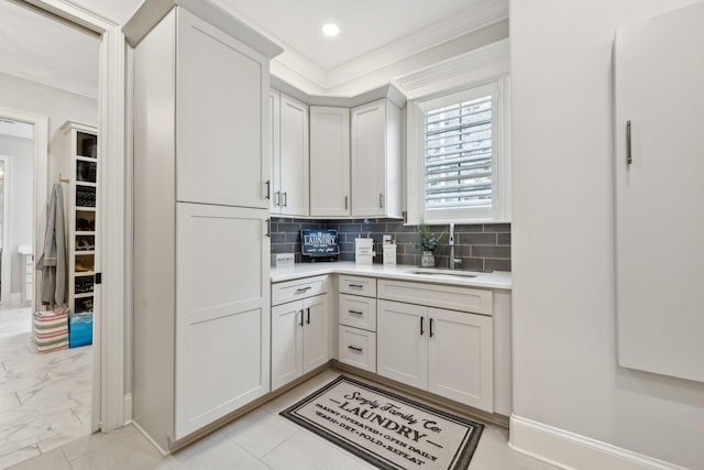 2143 White Poplar Ct, Murfreesboro, TN 37130 - kitchen with crown molding, light countertops, baseboards, decorative backsplash, and light marble finish floors