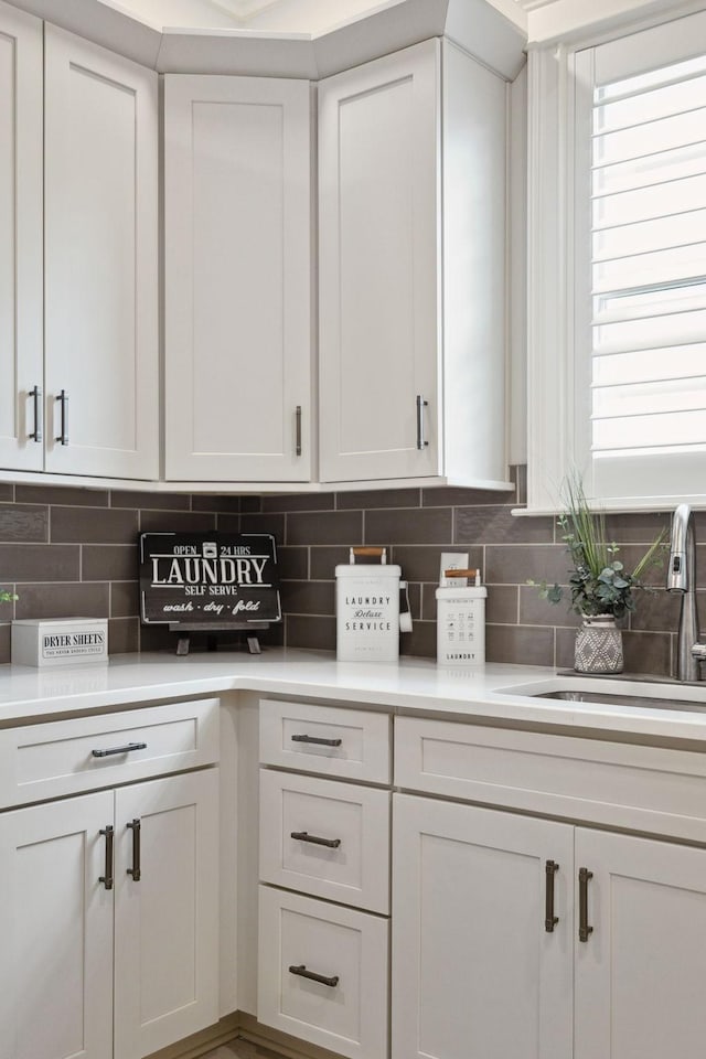 2143 White Poplar Ct, Murfreesboro, TN 37130 - kitchen with light countertops, backsplash, a sink, and white cabinets