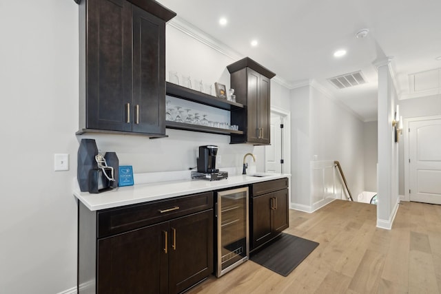 2143 White Poplar Ct, Murfreesboro, TN 37130 - kitchen featuring beverage cooler, crown molding, baseboards, light countertops, and light wood finished floors