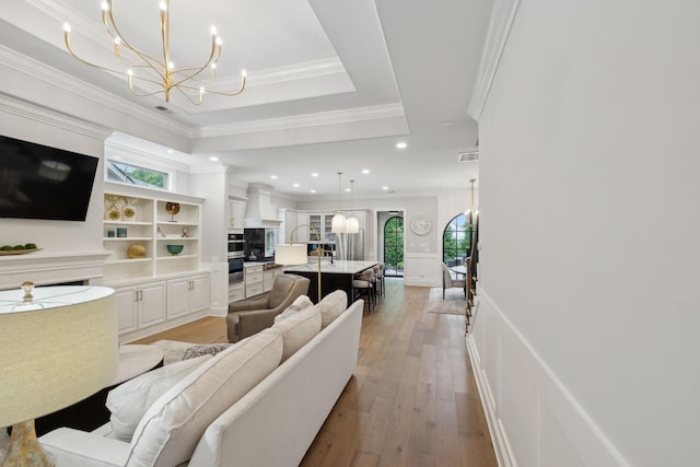 2143 White Poplar Ct, Murfreesboro, TN 37130 - living room with a chandelier, wood-type flooring, recessed lighting, ornamental molding, and a decorative wall