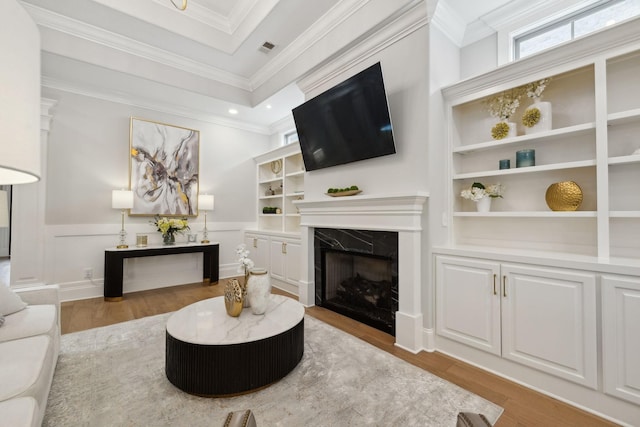 2143 White Poplar Ct, Murfreesboro, TN 37130 - living area with wood finished floors, healthy amount of natural light, built in features, wainscoting, and crown molding