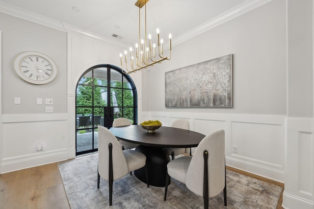 2143 White Poplar Ct, Murfreesboro, TN 37130 - dining area with a decorative wall, crown molding, wood finished floors, french doors, and a wainscoted wall