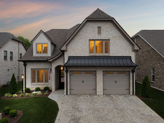 2143 White Poplar Ct, Murfreesboro, TN 37130 - french country style house with decorative driveway, a garage, a front yard, brick siding, and roof with shingles