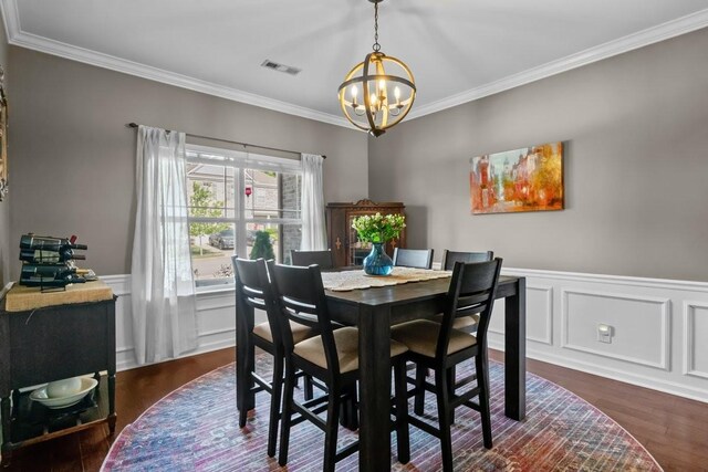 7211 Deervalley Dr, Fairview, TN 37062 - dining room with a chandelier, crown molding, dark wood finished floors, a wainscoted wall, and a decorative wall