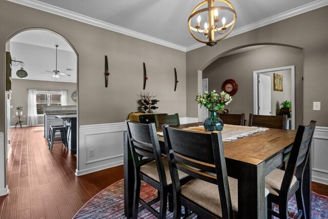 7211 Deervalley Dr, Fairview, TN 37062 - dining space with arched walkways, a chandelier, dark wood-style flooring, crown molding, and a ceiling fan